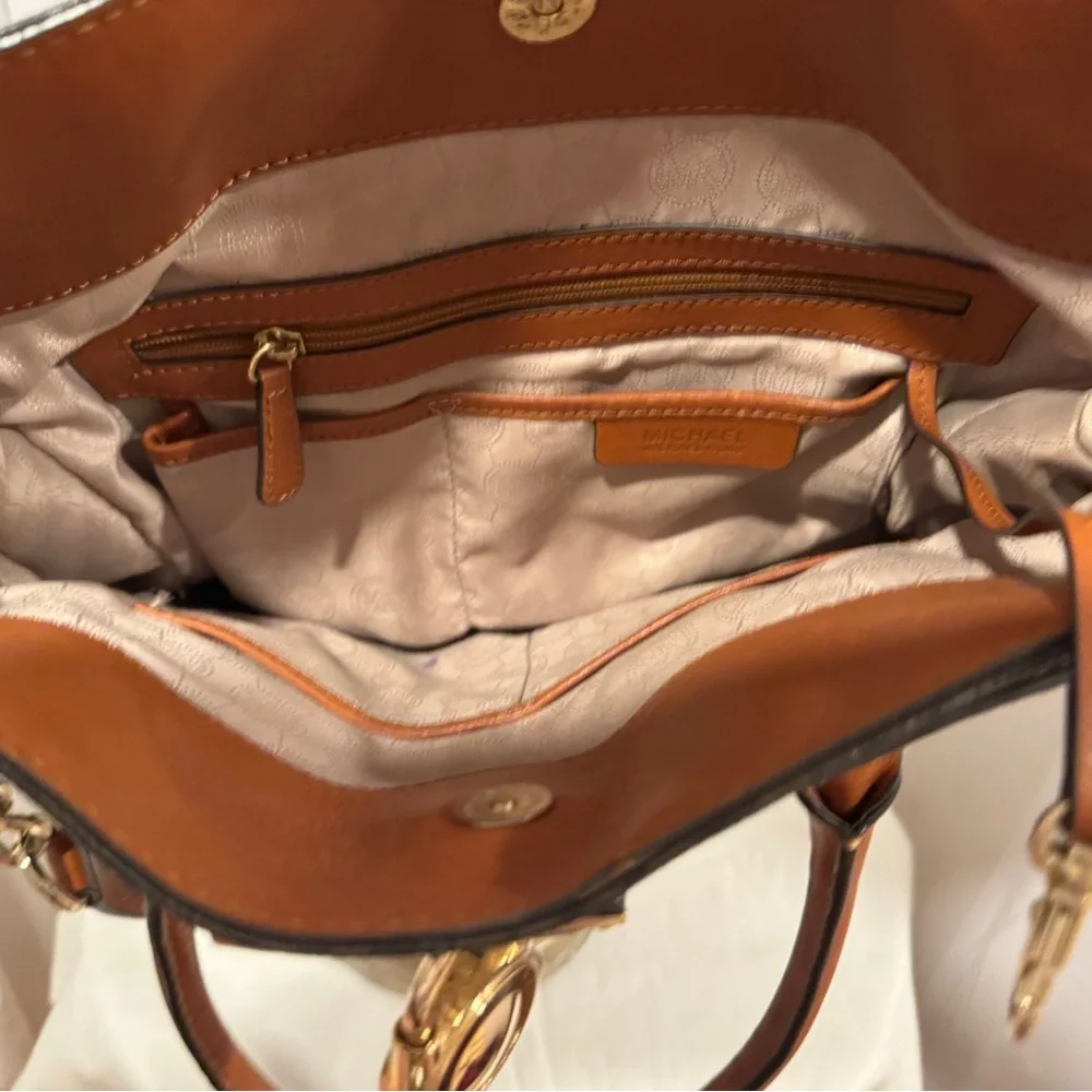 Michael Kors Emblemed satchel style purse. Strap has some gold chain and leather